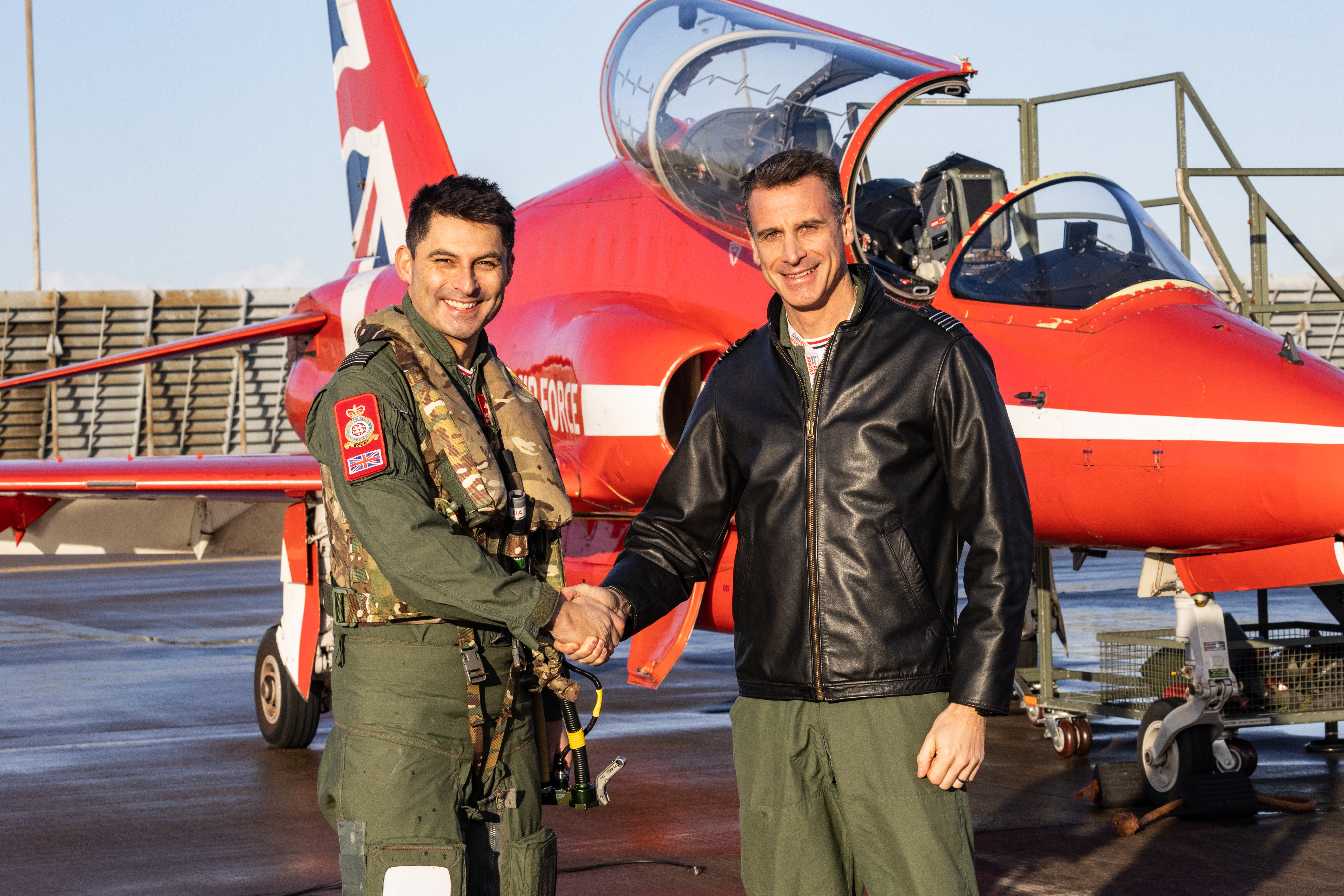 Wg Cdr Adam Collins, right, with Wg Cdr David Montenegro, left, after the departing Officer Commanding's final flight yesterday.